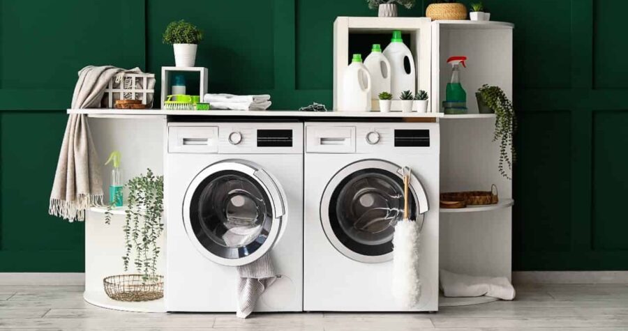 Laundry room with green walls washer dryer