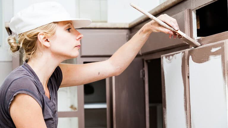 woman painting cabinets, woman painting, home improvements