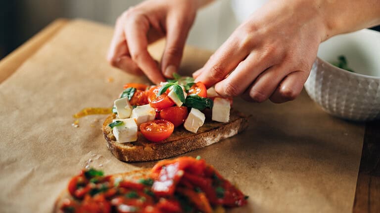Chef preparing caprese bruschetta in the kitchen
