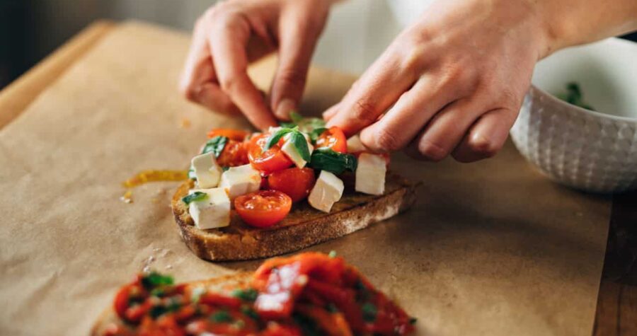 Chef preparing caprese bruschetta in the kitchen