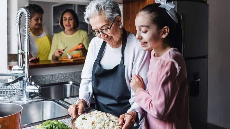 Girl cooking with her grandmother, grandma, learning, kitchen