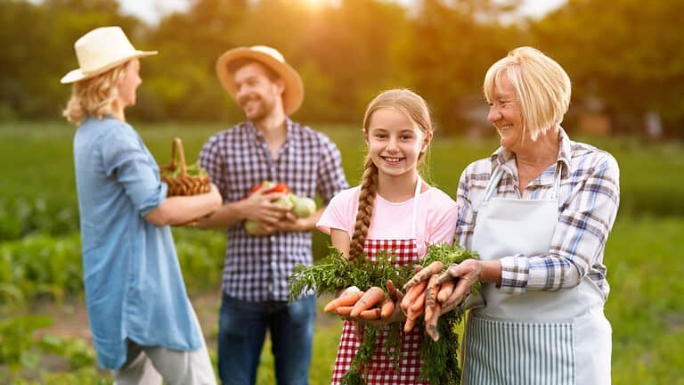 Satisfied rural family with own produced vegetables