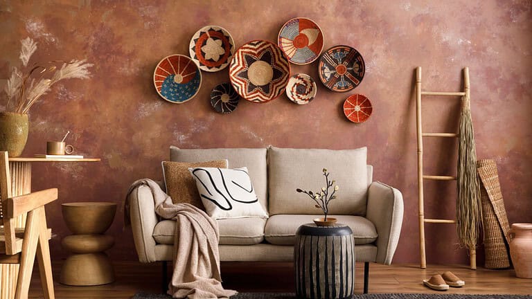 The stylish boho composition at living room interior with design beige sofa, coffee table, wicker baskets and elegant personal accessories