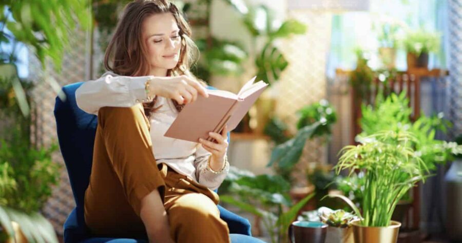 woman reading book, plants, gardening