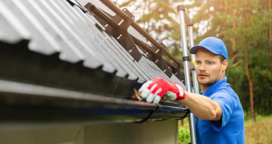 Man cleaning gutters, winterizing, home maintenance, gutters