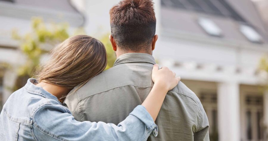 happy couple outside home, couple hugging, home