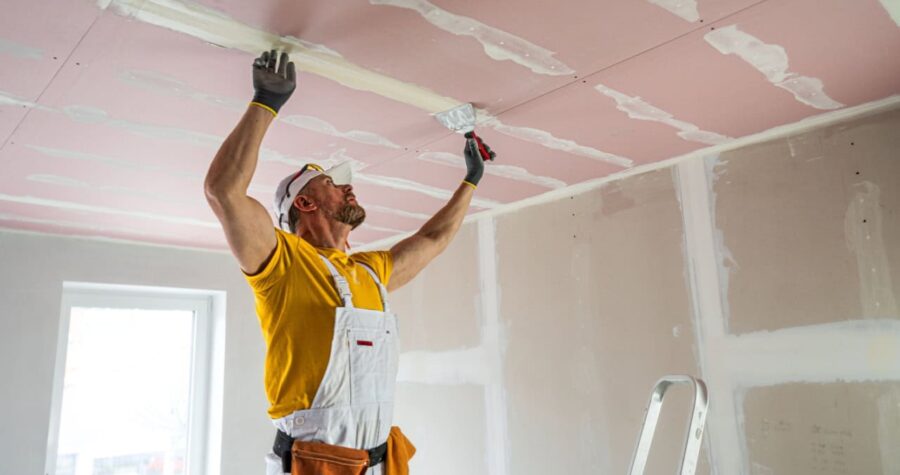 man installing drywall, home improvement, home renovation