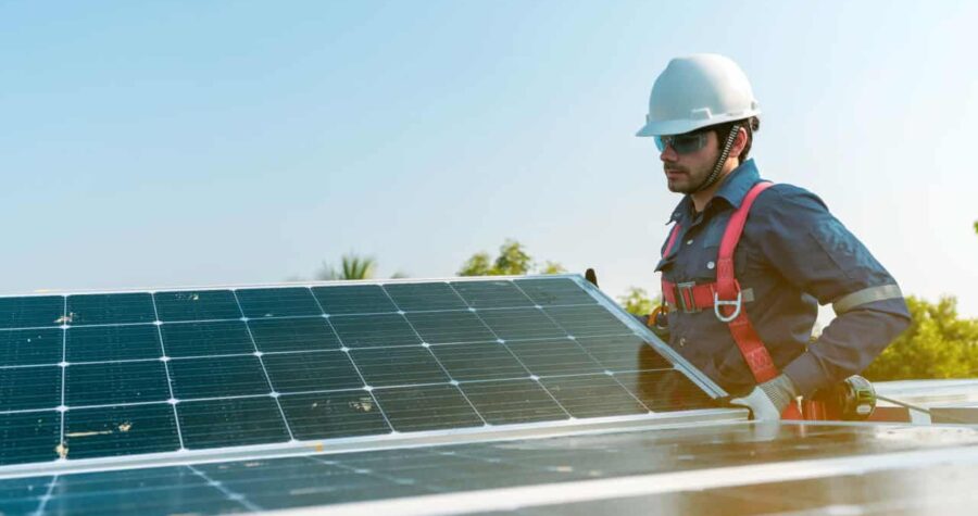 solar panels. man installing solar panels, energy efficiency