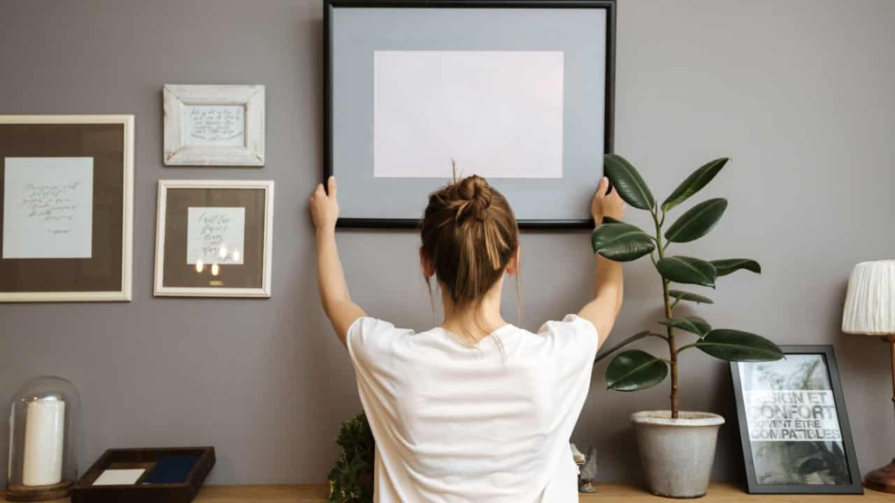 woman decorating, home decor, frame, artwork