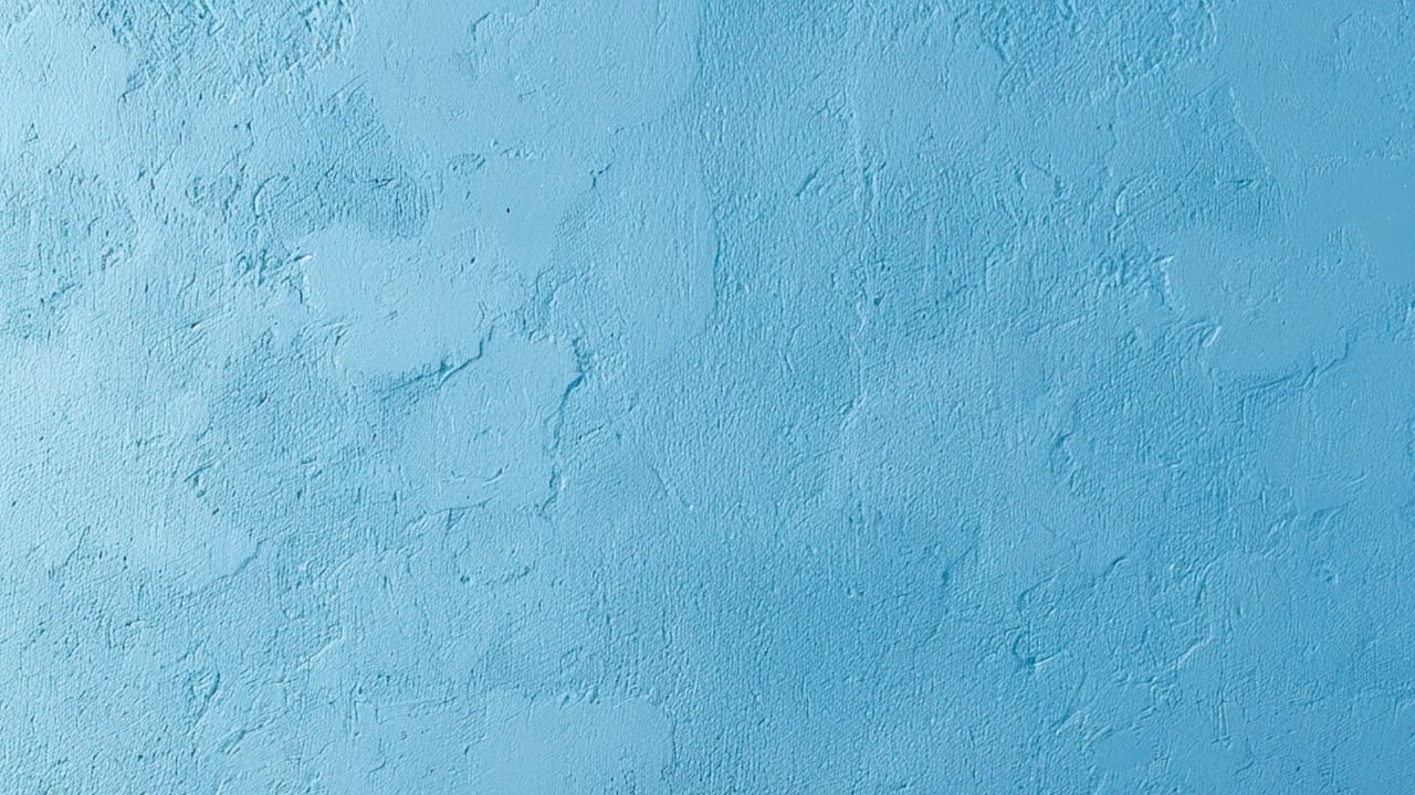 Textured blue wall, rough plaster surface, uneven paint application, abstract background, vibrant blue color, minimalistic design, decorative interior wall, artistic painted texture
