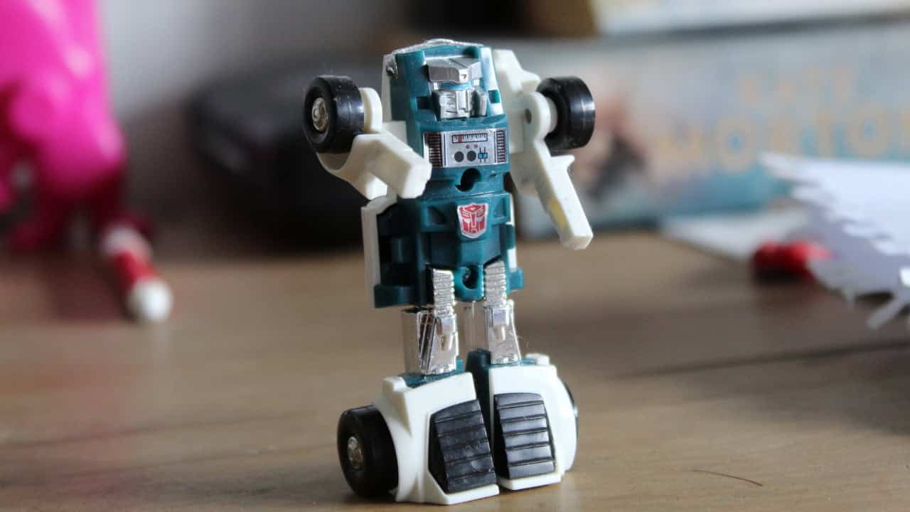 Transformers toy figure in robot mode standing on a wooden surface