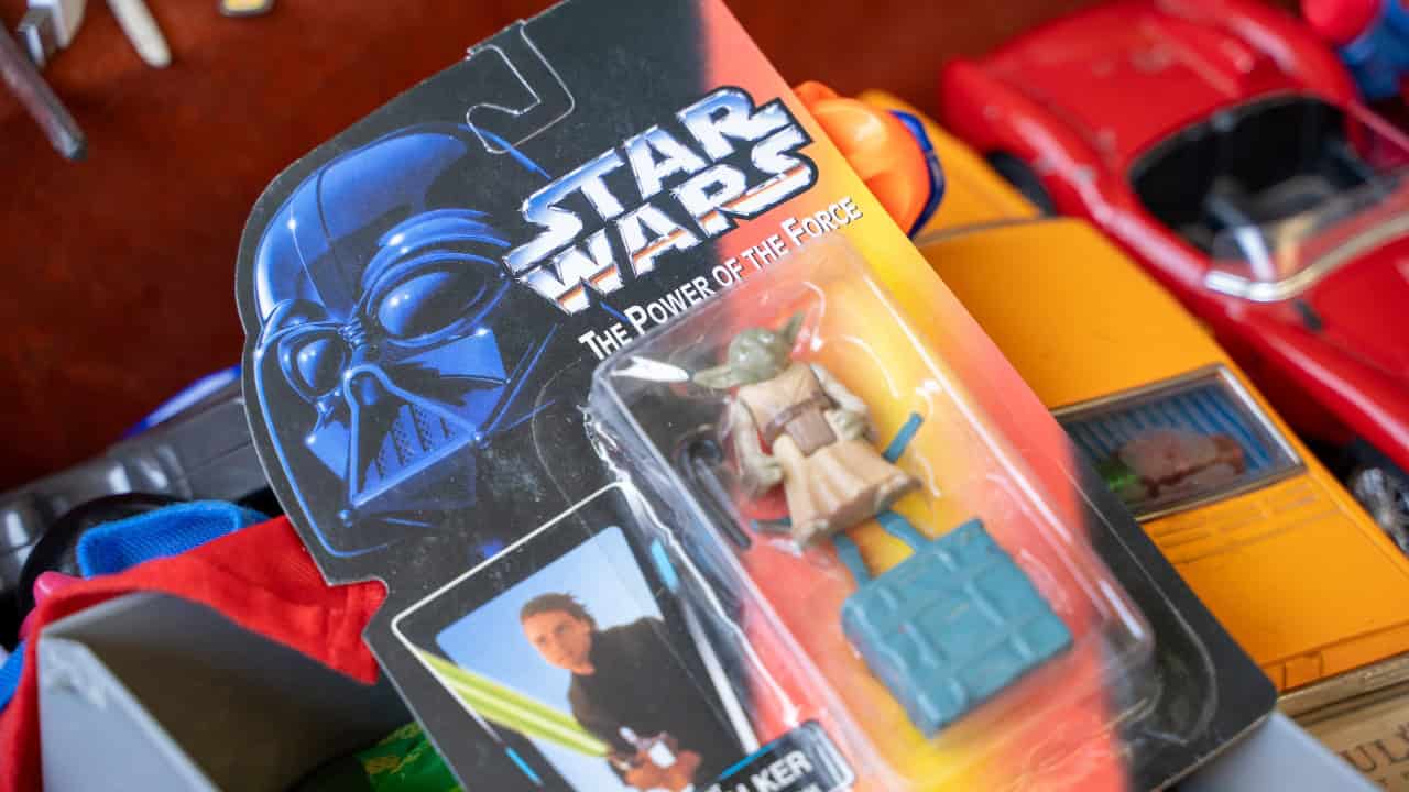 Packaged Star Wars action figure with Yoda on a cluttered toy surface, featuring The Power of the Force branding