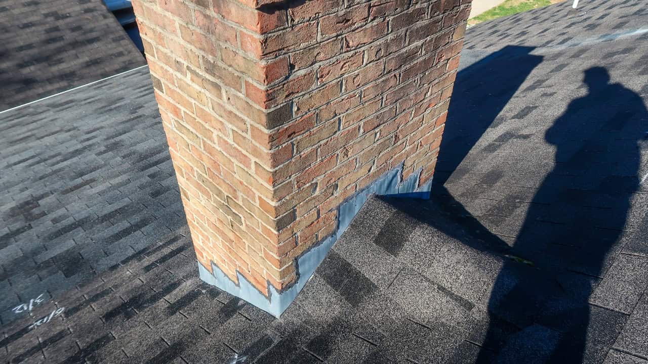 Technician inspecting chimney exterior with drone