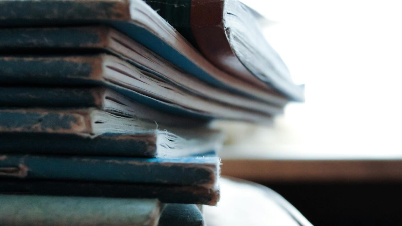 Artistic close-up of a stack of worn out notebooks with a vintage feel