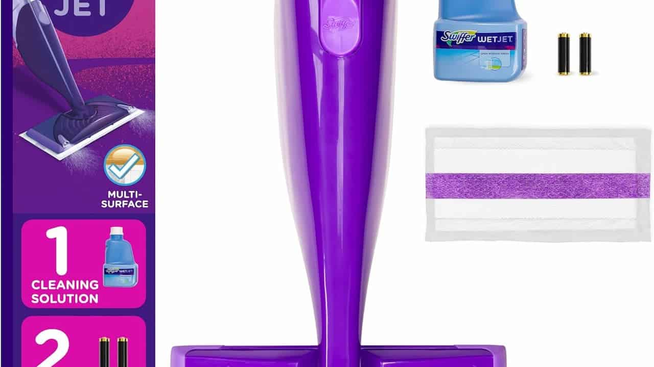 Purple Swiffer WetJet floor cleaner with accessories, including cleaning solution bottle, mop pad, and batteries, product packaging visible on left