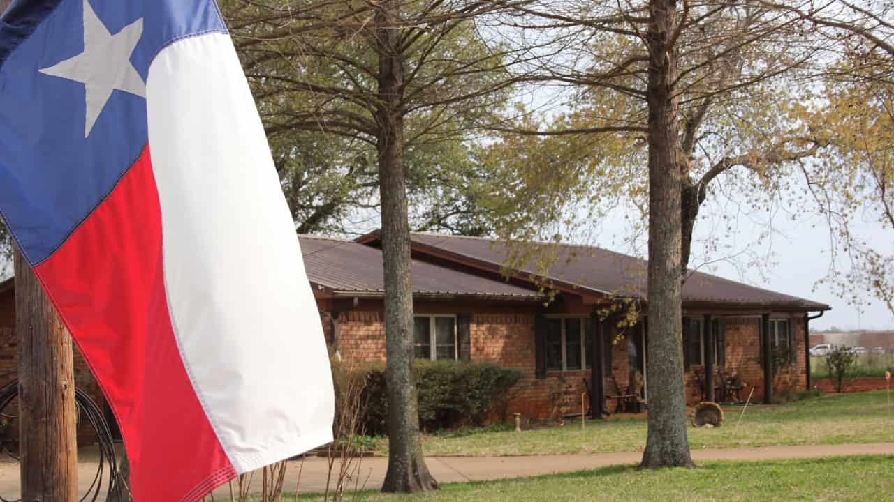Texas suburban house with well-kept lawn and driveway