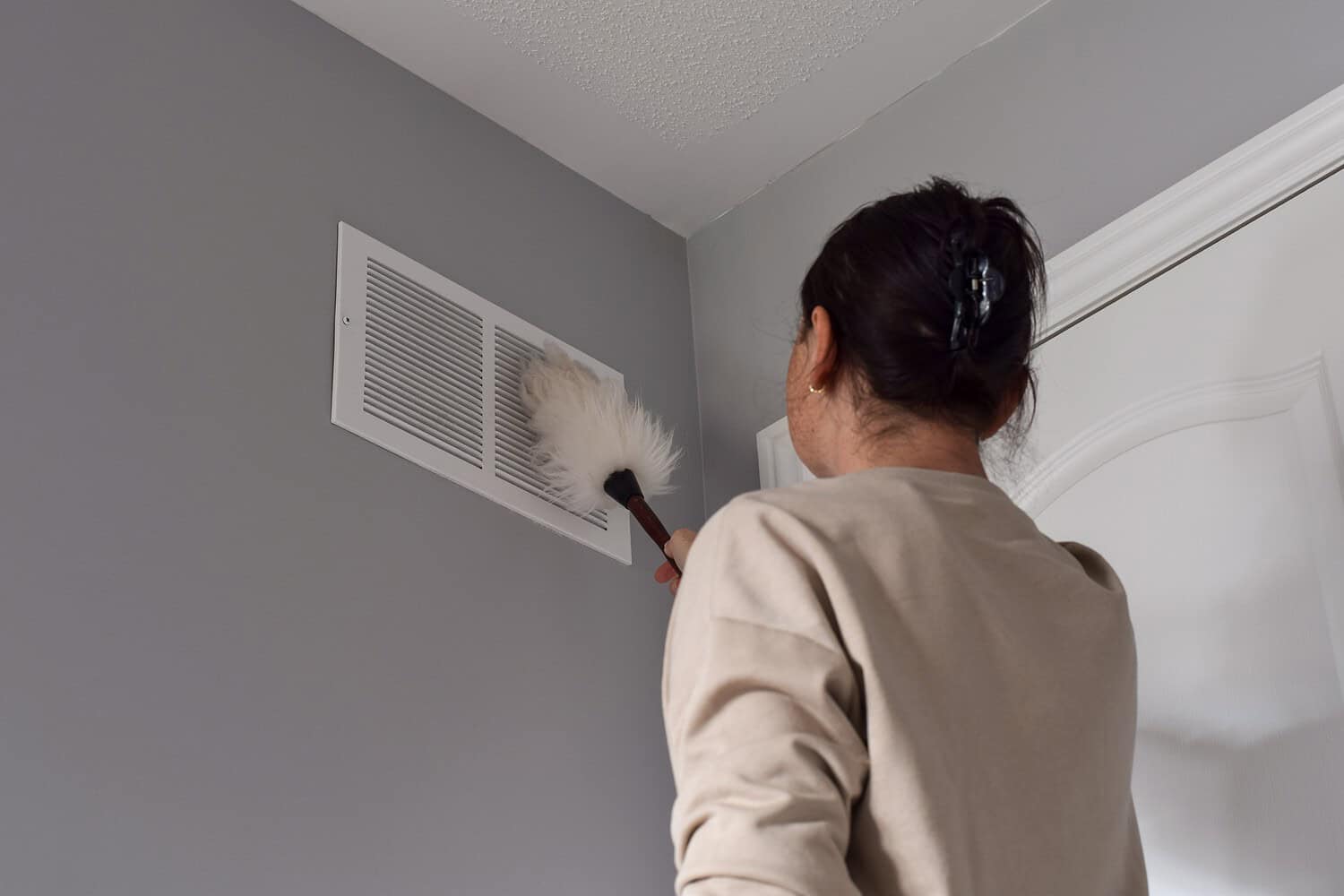 Woman,Cleaning,Return,Air,Vent,With,Duster