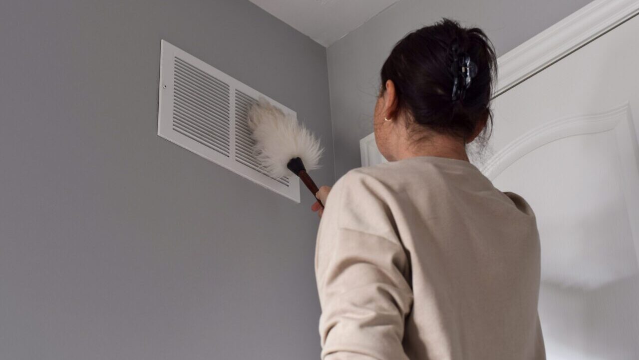 Woman,Cleaning,Return,Air,Vent,With,Duster
