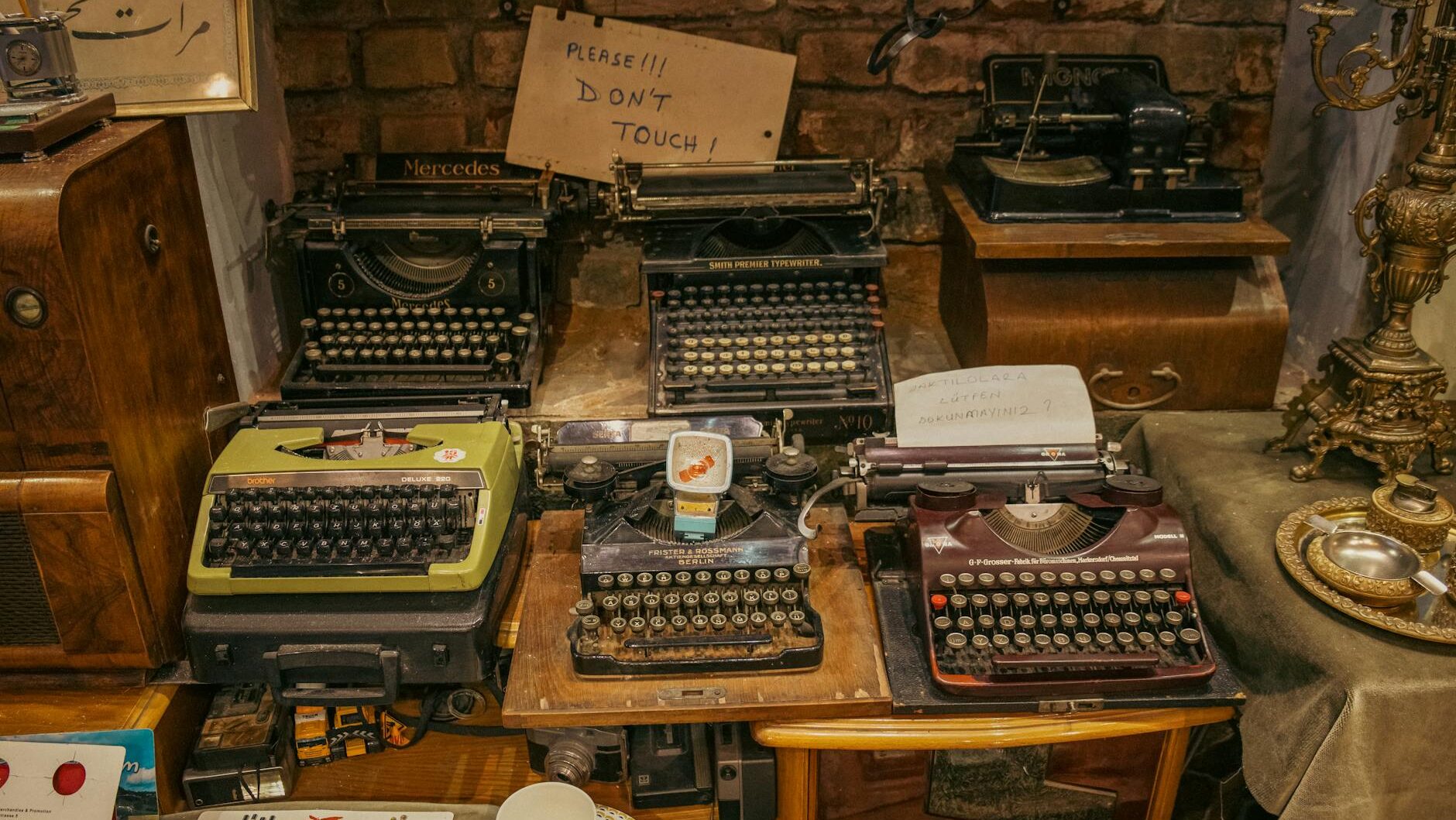 A collection of vintage typewriters displayed in an antique shop, creating a nostalgic retro ambiance