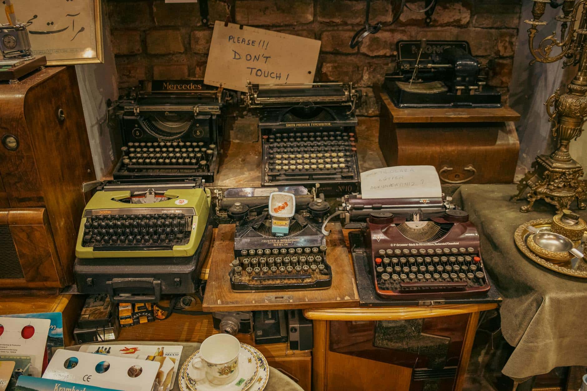A collection of vintage typewriters displayed in an antique shop, creating a nostalgic retro ambiance.