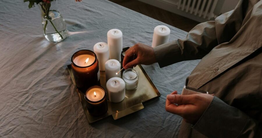 A warm and inviting indoor scene with lit candles and flowers on a table, perfect for relaxation.