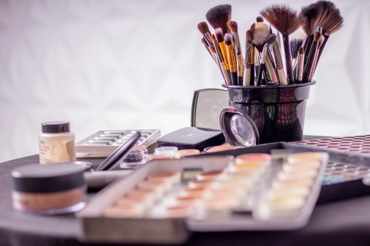 Close-up of a professional makeup brush set and cosmetics on a table for beauty use