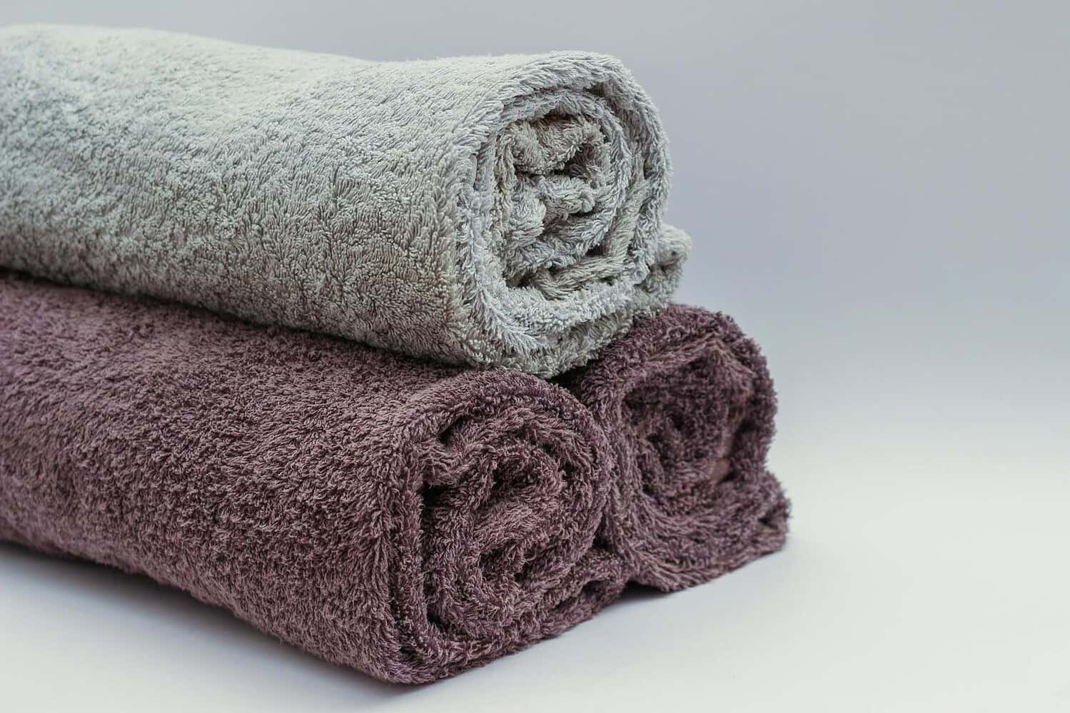 Close-up of rolled bathroom towels in neutral tones, ideal for interior design or spa themes