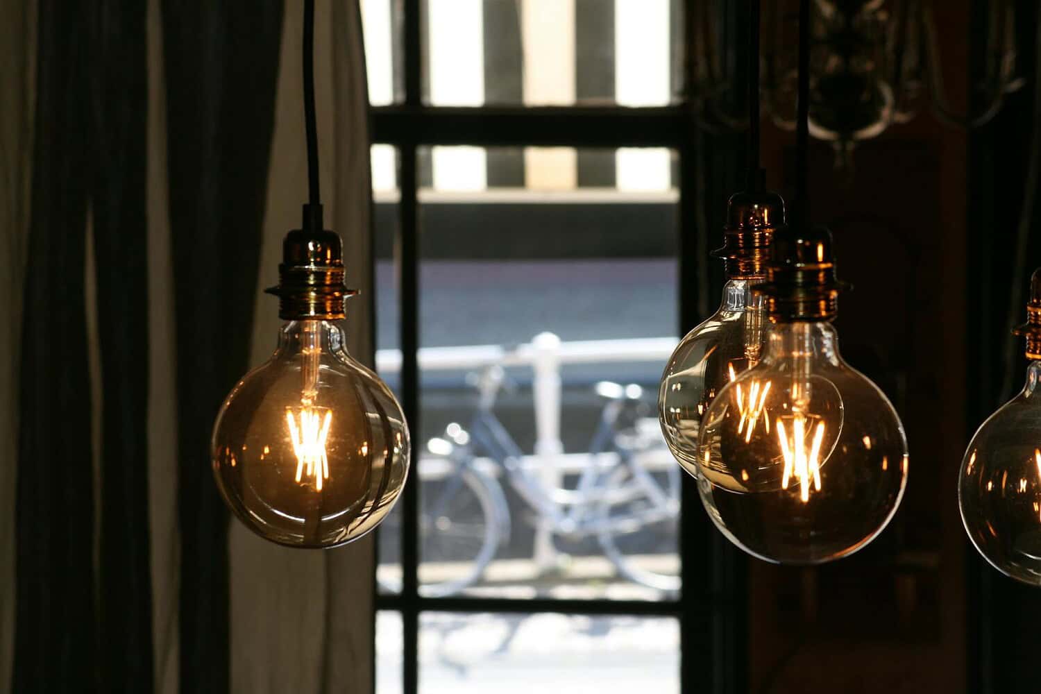 Close-up of vintage incandescent bulbs casting a warm glow in a cozy indoor setting