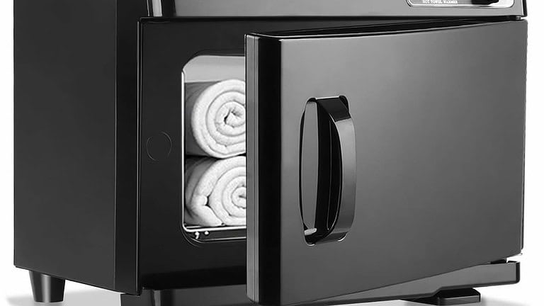 Black electric towel warmer, open door, rolled white towels inside, sleek design, countertop appliance