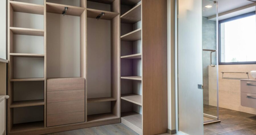 Spacious walk-in closet with wooden cedar shelves and minimalist style