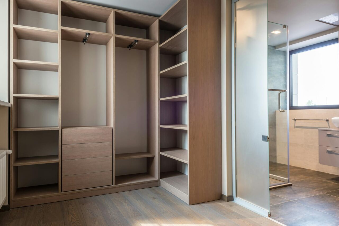 Spacious walk-in closet with wooden cedar shelves and minimalist style