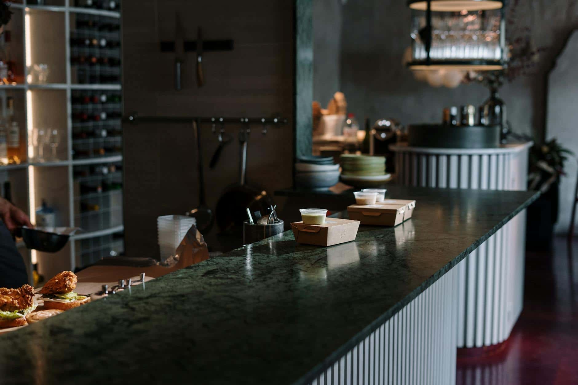 Upscale restaurant bar with elegant decor and gourmet takeout food.