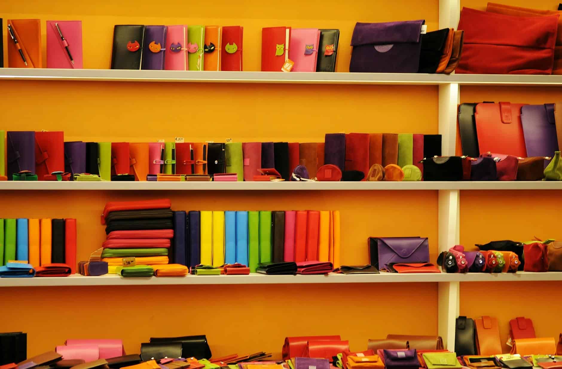 Vibrant assortment of wallets and bags displayed on retail shelves.