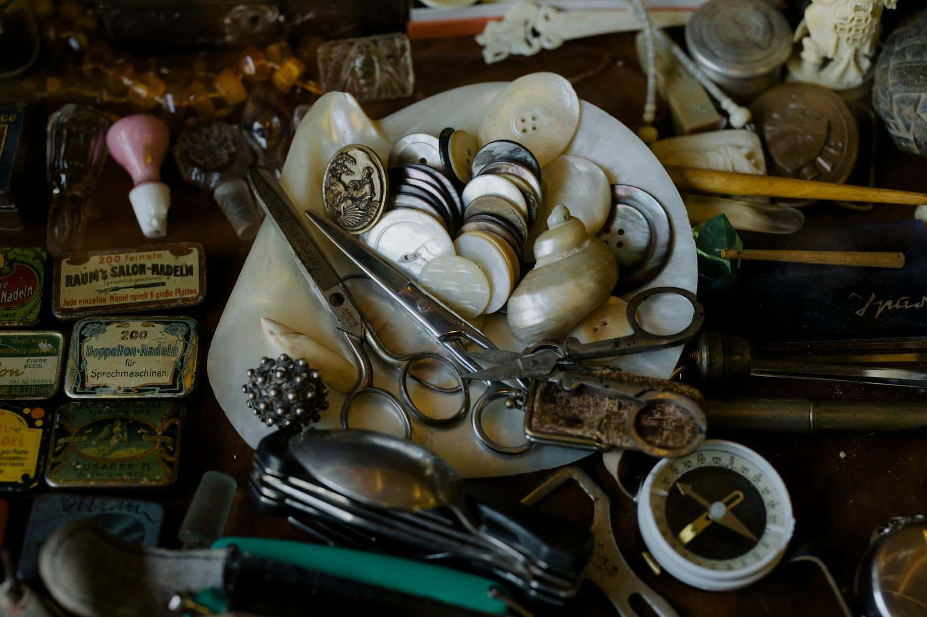 A collection of vintage tools, buttons, and trinkets displayed for nostalgic artistry.