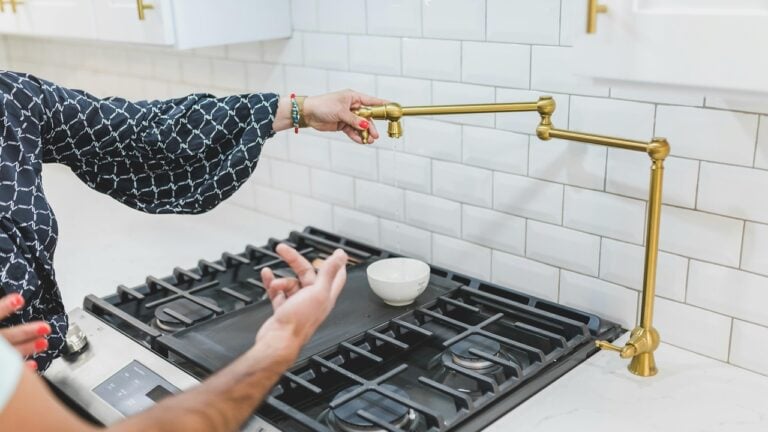 A Person Holding a Brass Faucet Tube