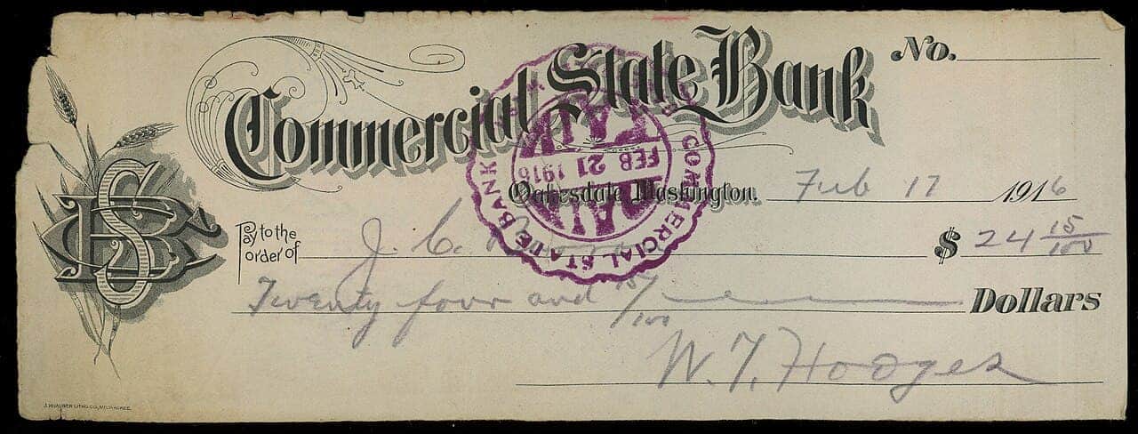 Vintage 1916 Commercial State Bank check, aged paper with ornate lettering, purple bank stamp, handwritten amount $24.25