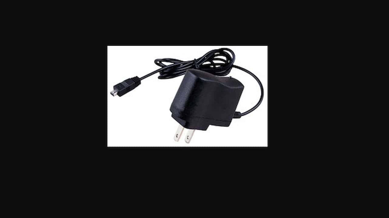 Black wall plug power adapter with a built-in cable ending in a mini-USB connector, placed against a white background