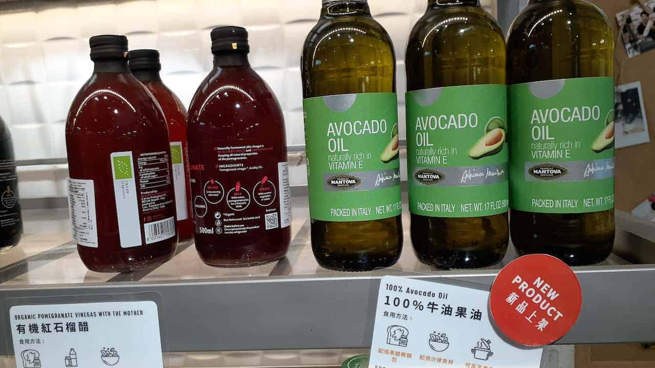 Bottles of organic pomegranate vinegar and avocado oil on a store shelf