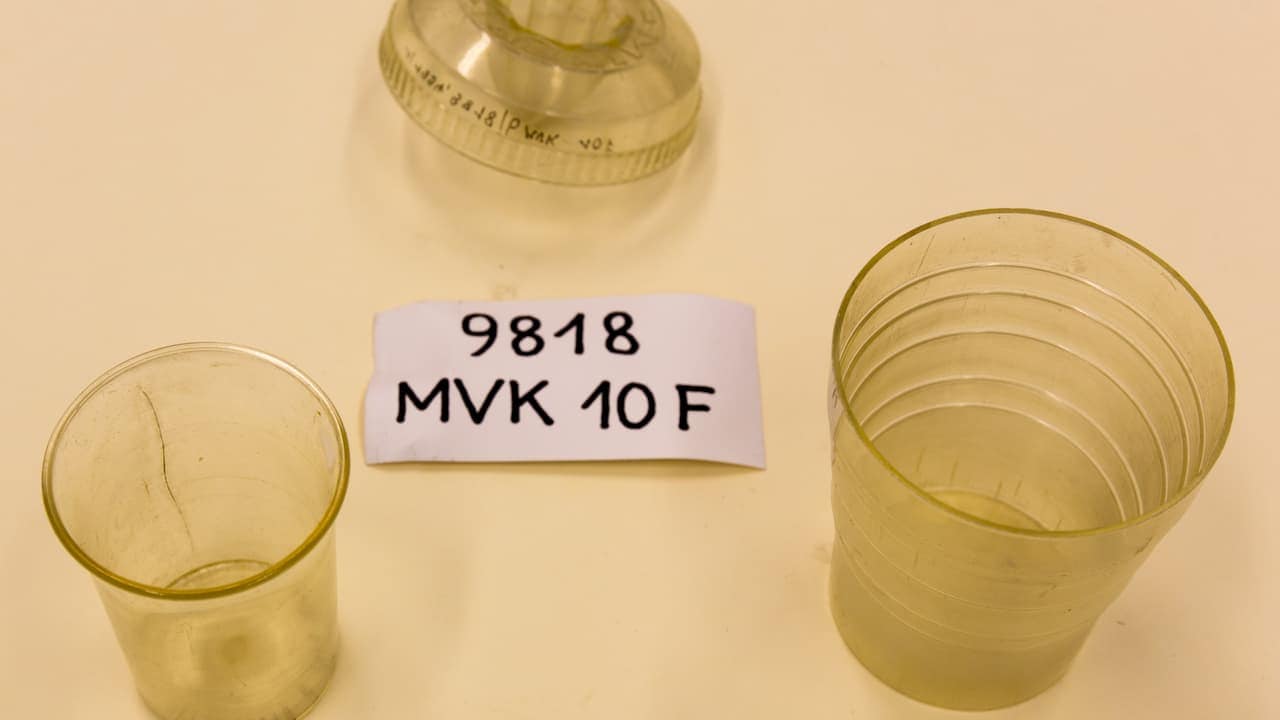 Components of a vintage water-powered egg mixer labeled “9818 MVK 10 F,” including translucent plastic cups and a conical top mechanism