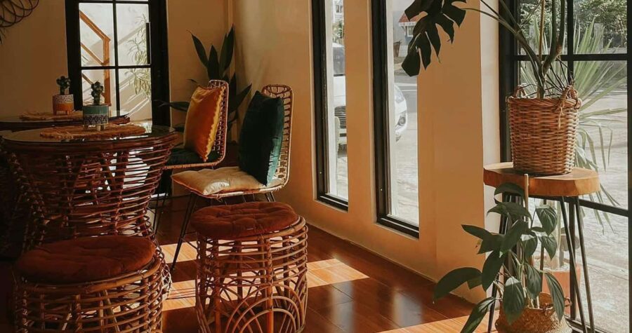 Wooden staircase with ornate carved balusters, decorative vase on step, warm lighting, and orange-toned walls