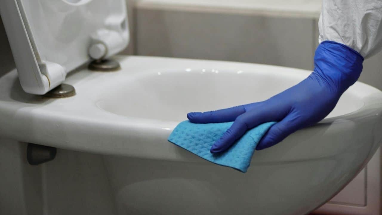 cleaning toilet with gloves