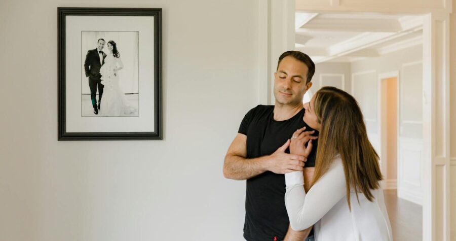 A Couple Smiling and Looking each other while Holding their Hands