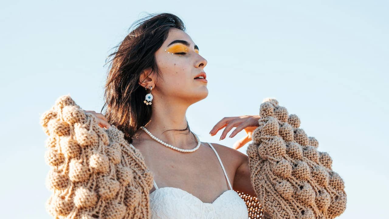 Woman wearing a cozy knit cardigan, soft textured fabric, relaxed fit, casual comfortable style