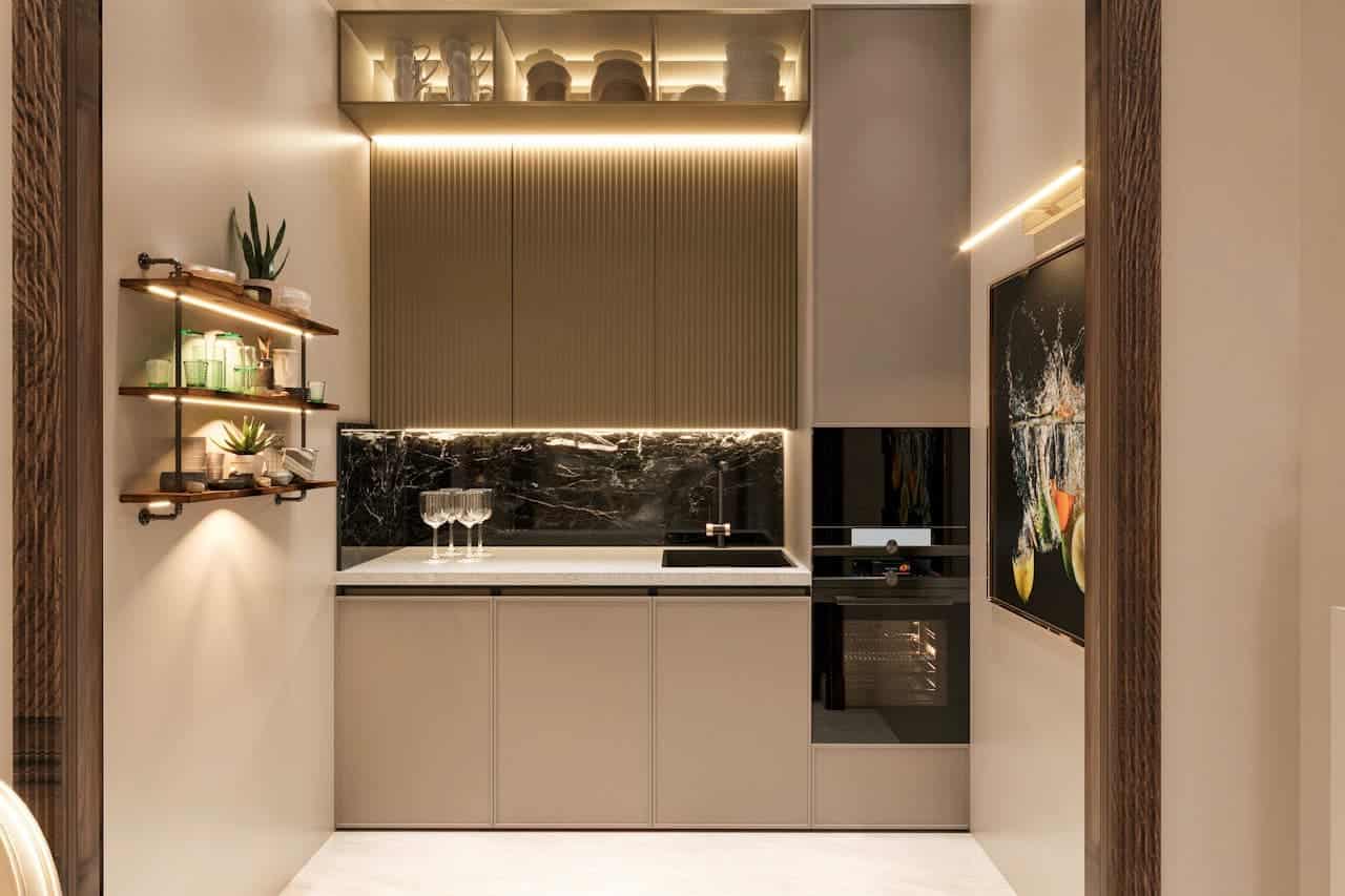 Modern compact kitchen with beige cabinetry, black marble backsplash, integrated appliances, LED strip lighting under shelves, potted plants, and ambient lighting