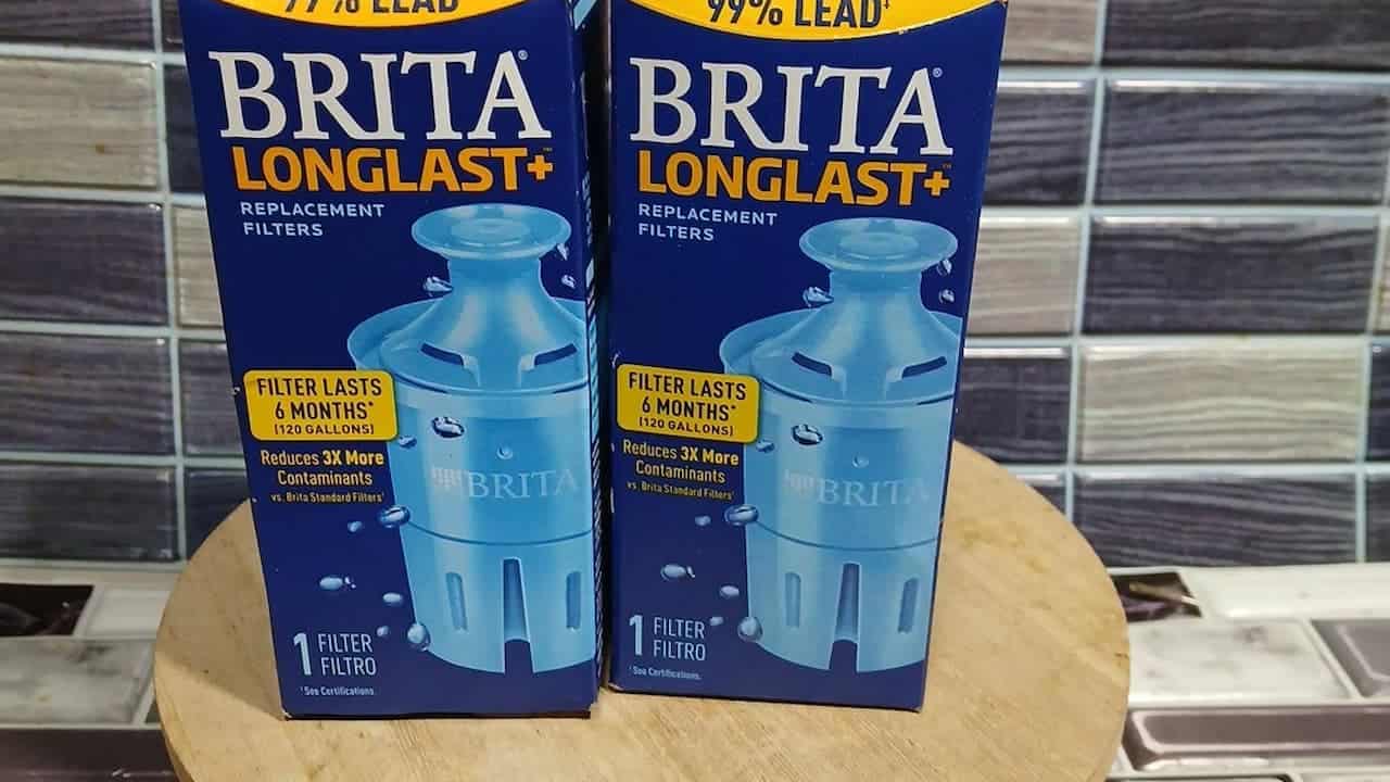 Two Brita Longlast+ replacement water filter boxes on wooden surface, removes 99% lead, lasts 6 months each