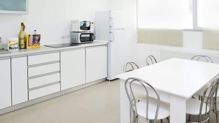 simple kitchen setup with all white couter tops and cabinets