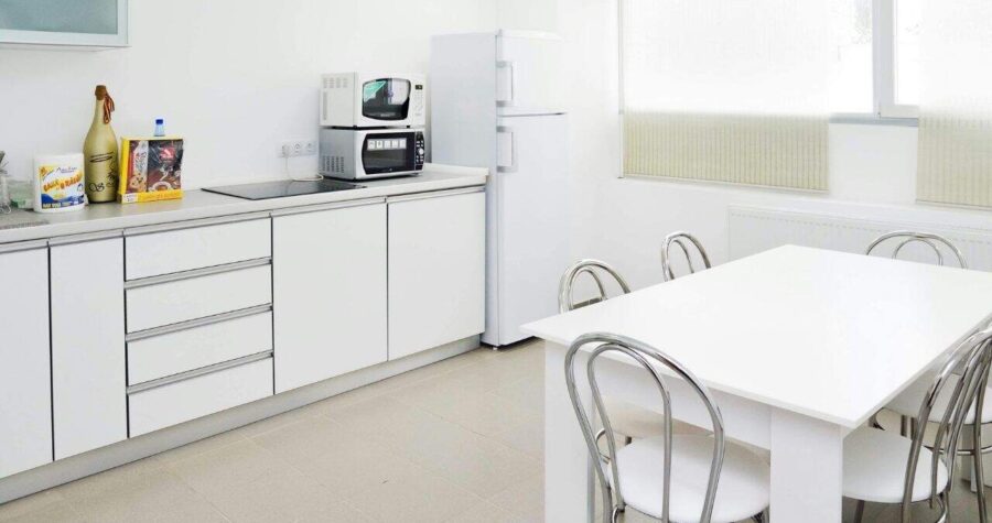 simple kitchen setup with all white couter tops and cabinets