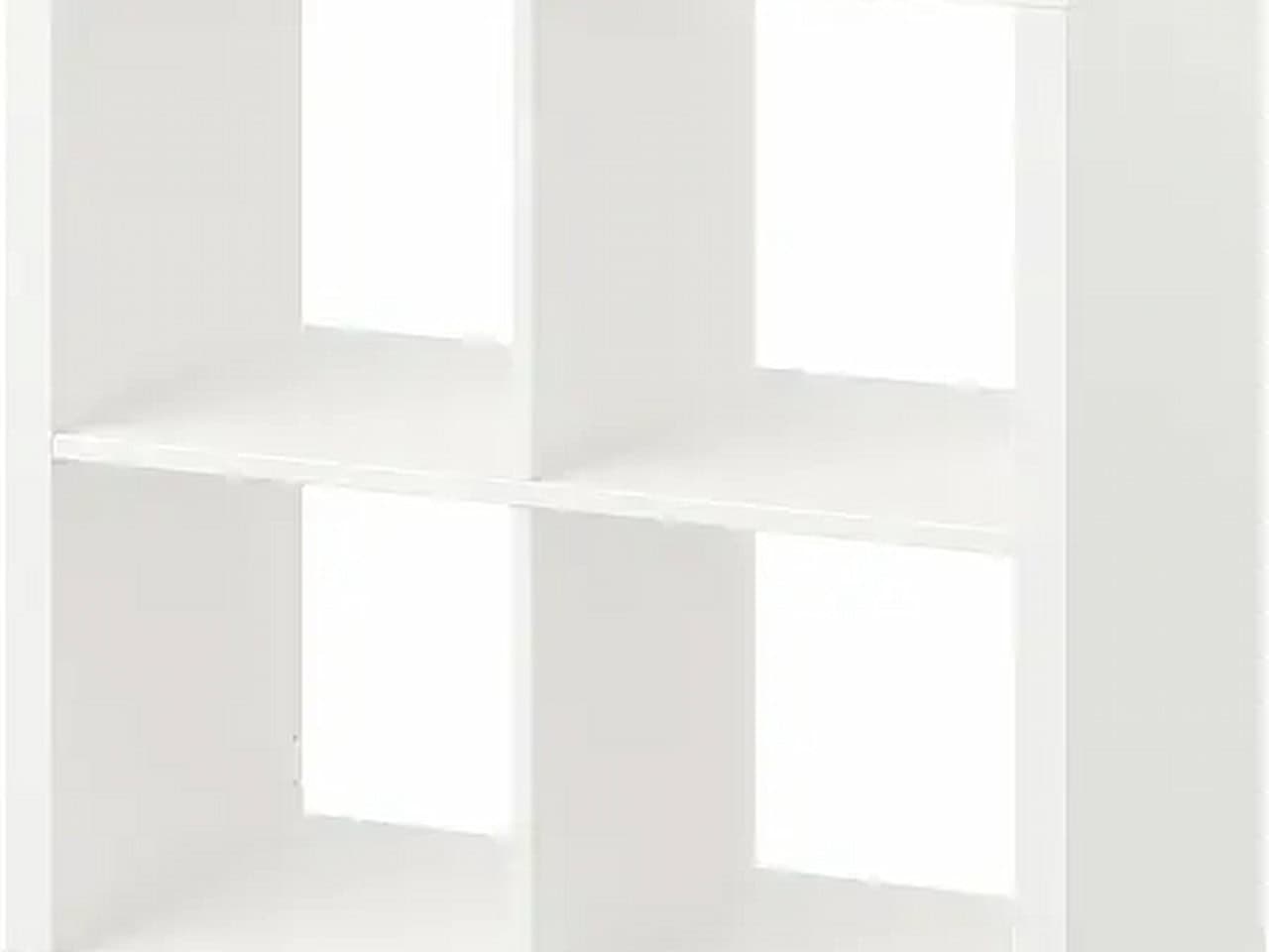 White four-cube bookshelf with two horizontal and one vertical divider forming four open storage compartments