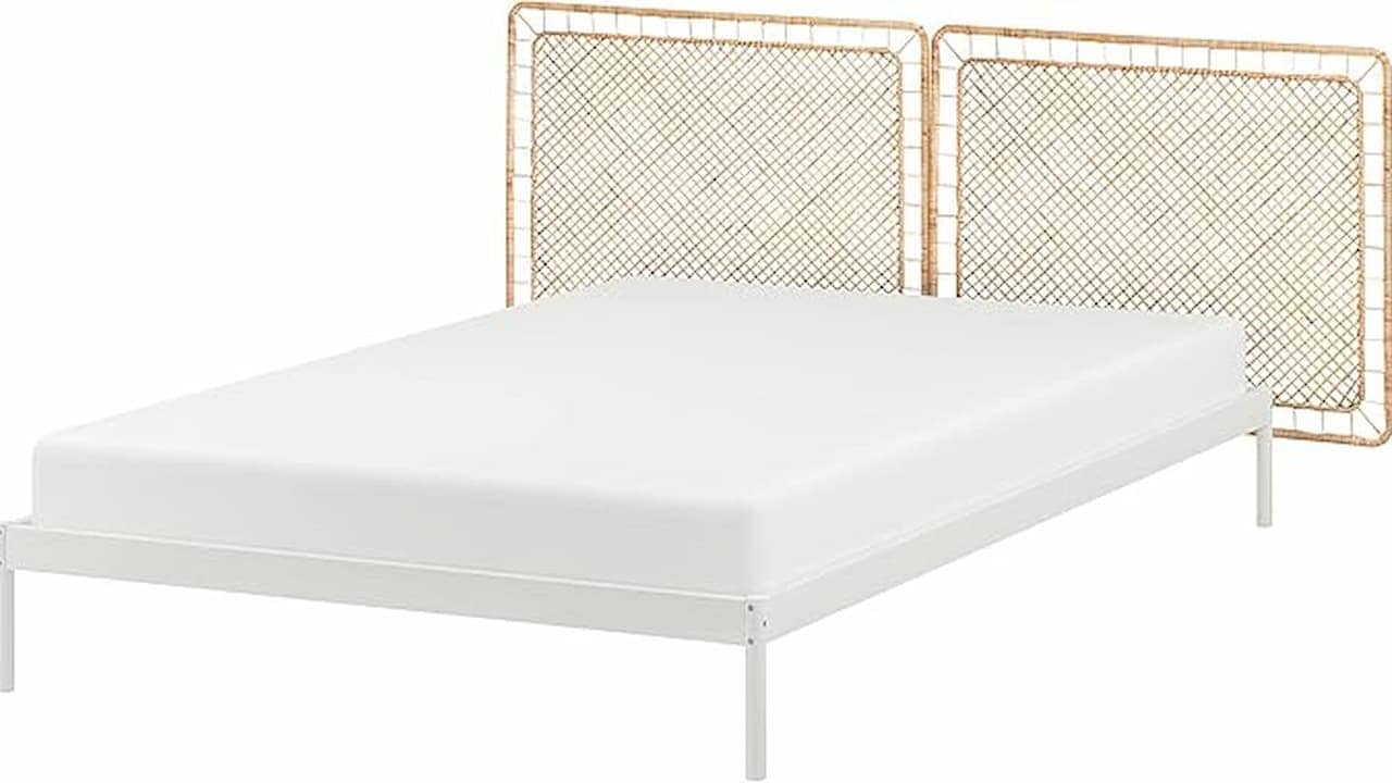  Minimalist white bed frame with a plain mattress and two woven rattan panels as headboards
