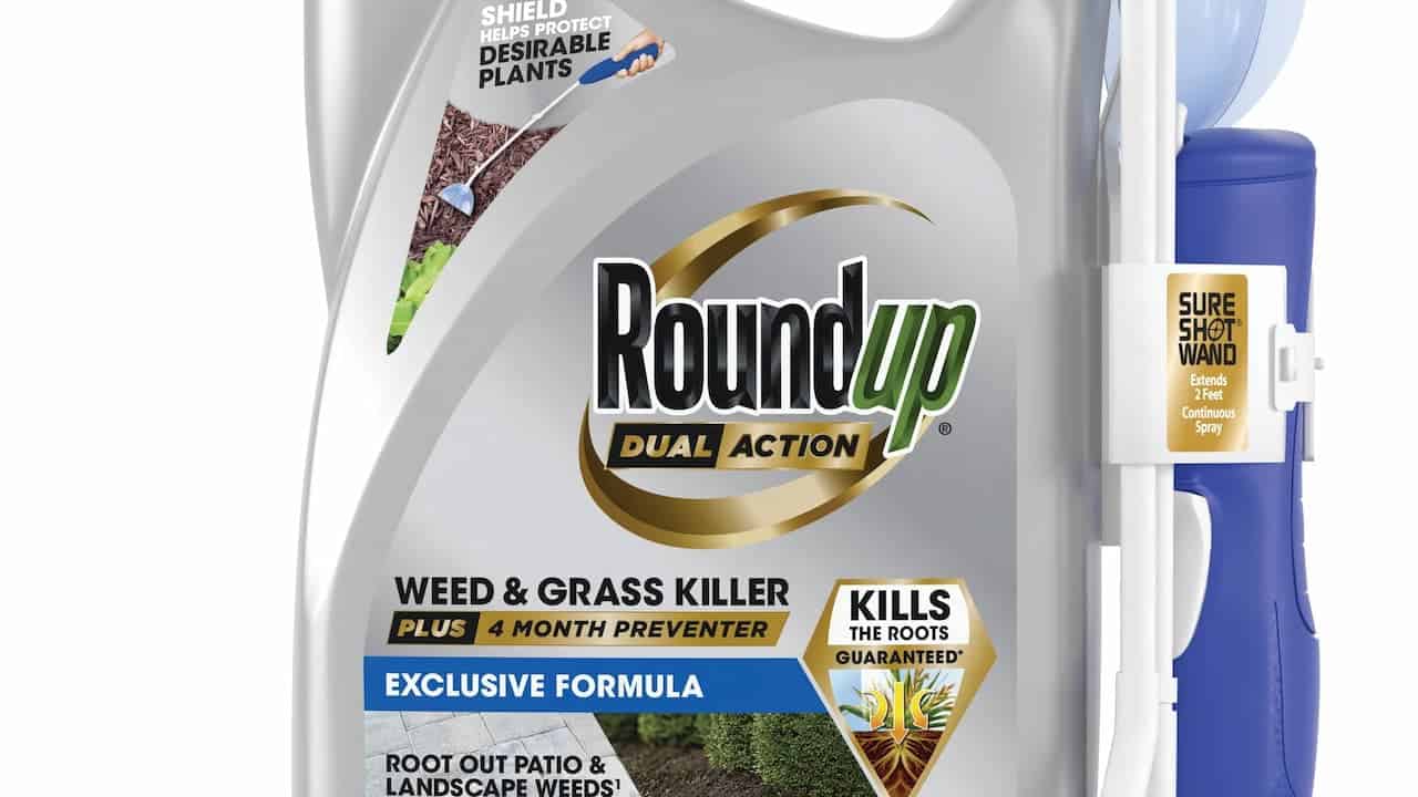 A container of Roundup Weed Killer placed on a garden path